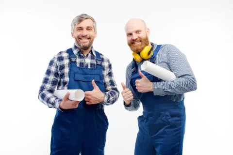 Two engineers smiling at camera on white background Stock Photos