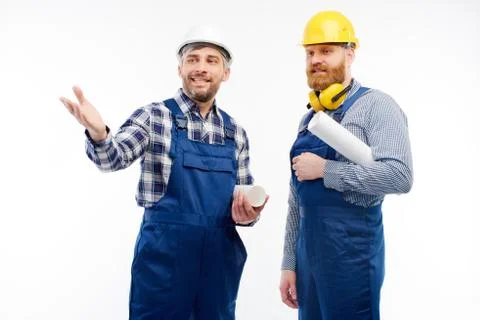 Two engineers smiling at camera on white background Stock Photos