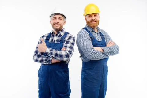 Two engineers smiling at camera on white background Stock Photos