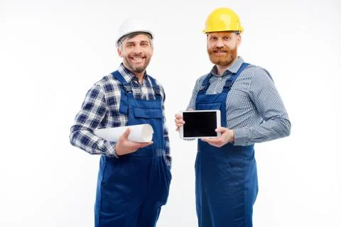 Two engineers smiling at camera on white background Stock Photos