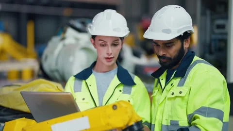 Two engineers study equipment with laptops Stock Footage 347352256