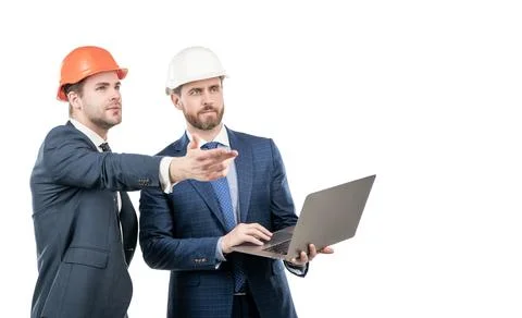 Two engineers in suit and protective helmet use laptop isolated on white copy Stock Photos