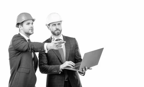 Two engineers in suit and protective helmet use laptop isolated on white copy Stock Photos