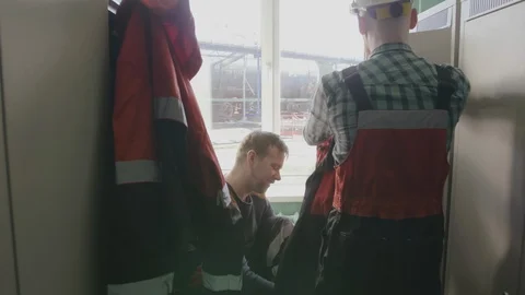 Two engineers in uniform discuss scheme of construction site before one of them Stock Footage 109532416