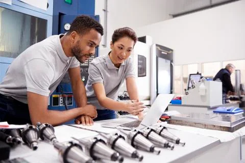 Two Engineers Using CAD Programming Software On Laptop Foto stock