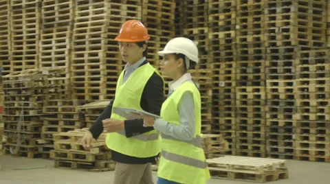 Two engineers using digital tablet and planning in factory Stock Footage 31878053