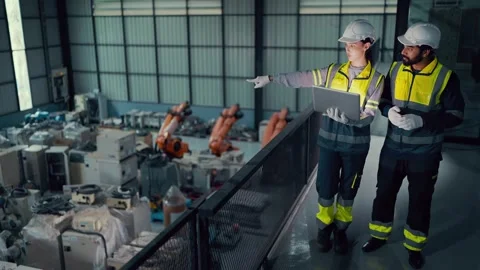 Two engineers walk through an industrial facility Video stock 340986507