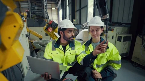 Two engineers wear hard hats and high-visibility vests Video stock 340987079