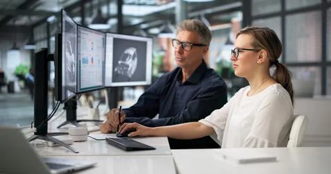 Two Engineers Work Together On 3D Car Gearbox Design Using Computer. 스톡 사진