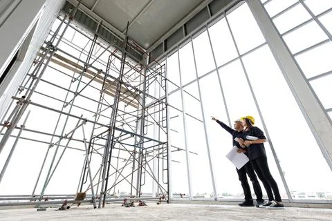 Two engineers working in construction site together Stock Photos