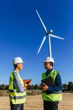 Two engineers working in renewable energy. Stock Photos
