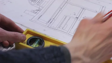 Two engineers working on same project and measuring its details on printed .. Stock Footage 233440559