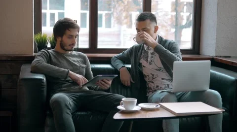 Two entrepreneurs working and taking notes together in table of little office Stock Footage 68178689