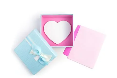 Two envelopes and a gift box with a heart on a light background. Stock Photos