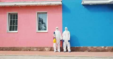 Two epidemiologists team work on disinfection against coronavirus COVID-19. Video stock 131095334