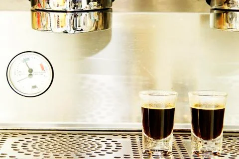 Two espresso shots on coffee machine background Stock Photos