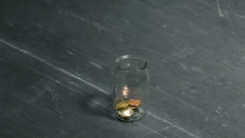 A two-euro coin is placed in a jar Stock Footage 145280344