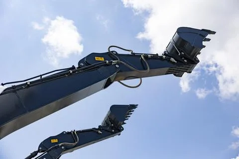 Two Excavator buckets on the background of construction equipment Stock Photos