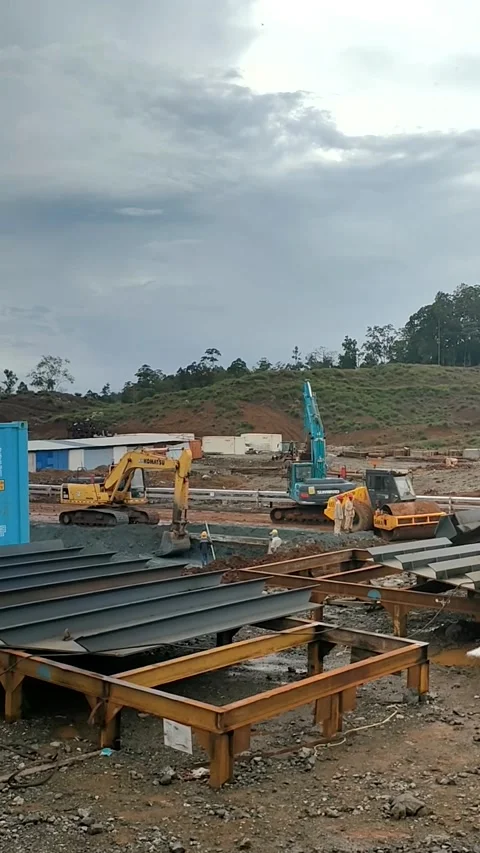 Two Excavators and Vibratory Roller at Industrial Construction Site Stock Footage 340310955