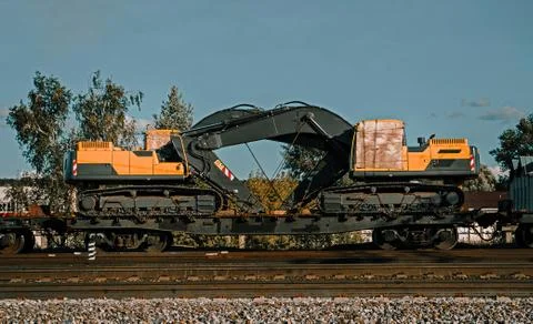 Two excavators on a railway platform. Two heart-shaped buckets. Stock Photos