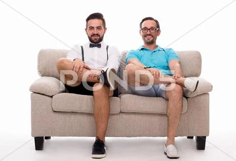Two Excited Men Sitting On Couch
