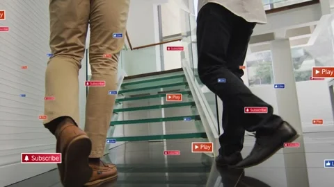 Two execs walking glass stairs, stepping onto treads and causing floating icons Stock Footage 331270227