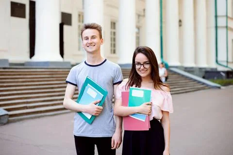 Two exemplary students in front of old university Stock Photos