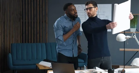 Two experienced Architects Making Design Corrections on their Blueprints. They Stock Footage 126162161