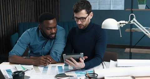 Two experienced Engineers and Architects working on PC Tablet in modern Office Stock Footage 126234886