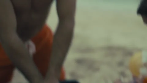 Two experienced Lifeguards performing CPR on the beach Stock Footage 263918569