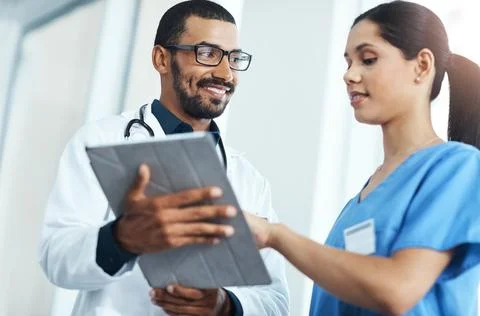 Two experts are better than one. two young doctors using a digital tablet in a Stock Photos
