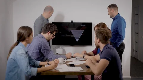 Two experts are performing at business meeting and demonstrating plan of sales Stock Footage 120725755