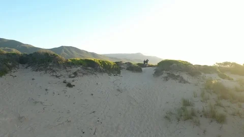 Two explorers hiking a mountain sand dune sunset / sunrise Stock Footage 127303524