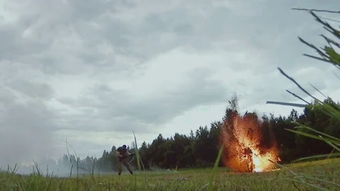 Two explosions with fire and smoke. Slow motion. Man under fire. Battlefield Video stock 79568016