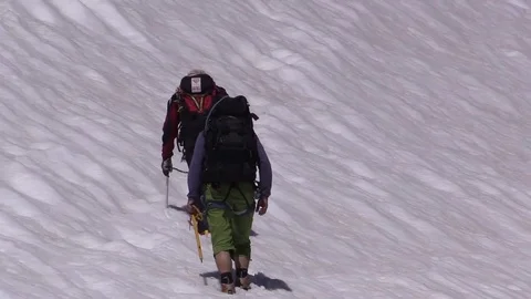 Two extreme mountain hikers Stock Footage 77952356