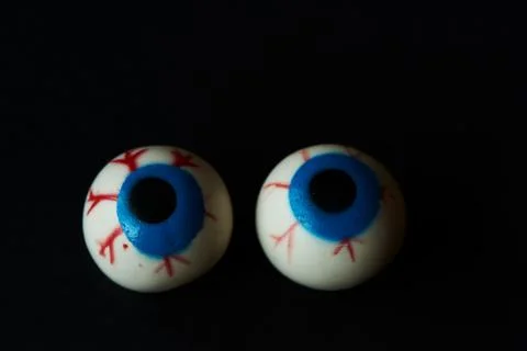 Two eyeballs on black background Stock Photos