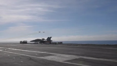 Two F/A-18 Hornets make a low-level flypast of USS Theodore Roosevelt (CVN 71) Stock Footage 260385853
