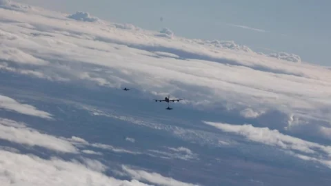 Two F-35A Lightning II aircraft flying with KC-135 Stratotanker refueler Stock Footage 263887869