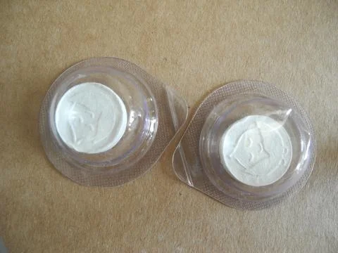 Two facials sheet masks in a capsule on a beige background Foto stock