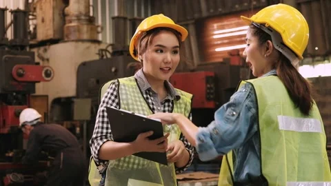 Two factory female engineers talking and checking production report Stock Footage 130191384
