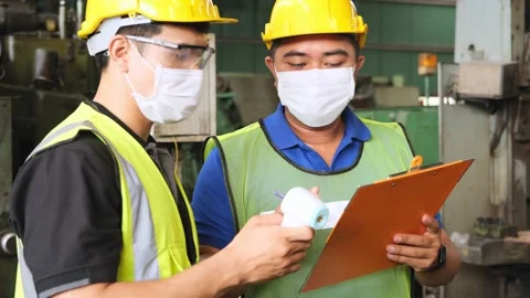 Two factory worker with hygiene mask face talk about body temperature. Stock Footage 141235751