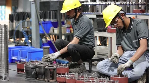 Two factory workers in collaborating on ... | Stock Video | Pond5