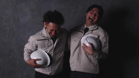 Two Factory Workers Laughing Together While Holding Safety Helmets Stock-Footage 344085713