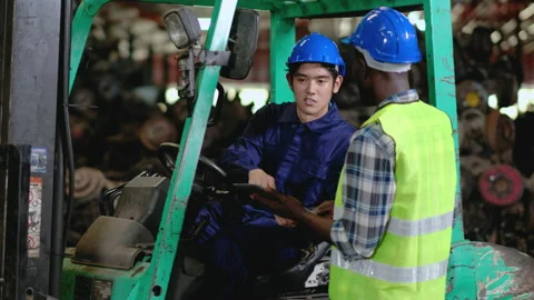 Two factory workers or technician man with one stay on forklift truck Stock Footage 142629168