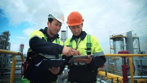 Two factory workman check and discussing working technology with paper document Video stock 100144017