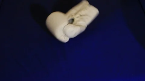 Two falling white boxing gloves Stock Footage 87665977