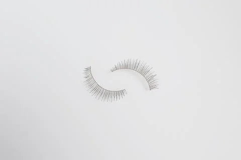 Two false eyelashes against plain white background with space for copy Stock Photos