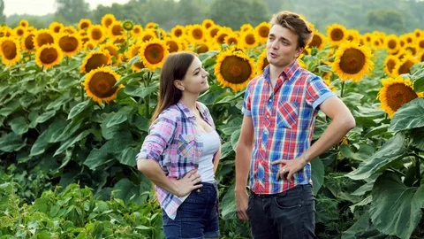 Two farmers are talking, man and woman in the agrarian sphere, talking in a Stock Footage 113300596