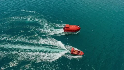 Two fast rescue boats creating white wake trails  Stock Footage 335797996