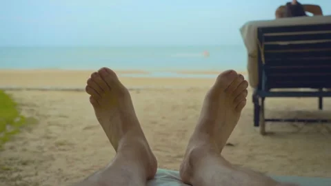 Two feet closeup on the white sand beach blue sky and sea on a holiday Stock Footage 290217561